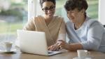 Junge und alte Frau vor Laptop