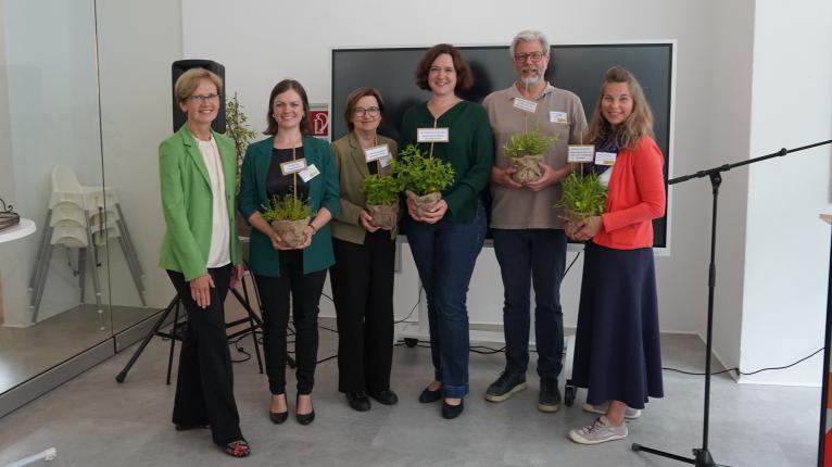 Margareta Büning-Fesel übergibt symbolische Kräutertöpfe zum Projektauftakt.